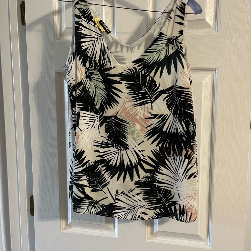 Shell top, lined. Looks great under a jacket or on it song excellent condition